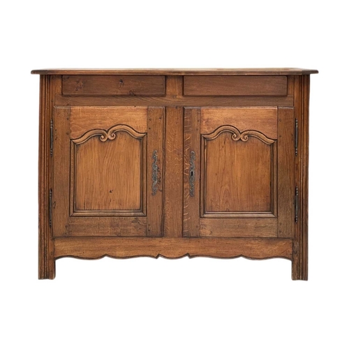 792 - A Breton chestnut side cabinet. 19th century, two handleless front drawers above two carved fielded ... 