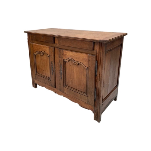 792 - A Breton chestnut side cabinet. 19th century, two handleless front drawers above two carved fielded ... 