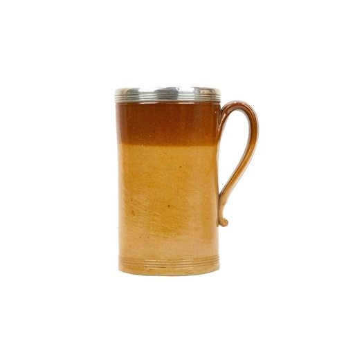 799 - A large Victorian brown salt glazed mug, with a silver mounted rim. Hallmarked London, 1870, height ... 