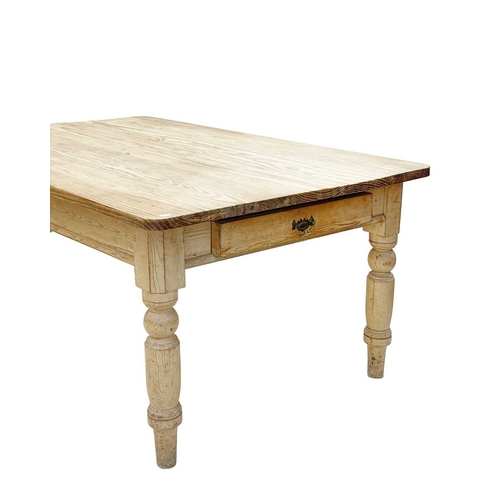 804 - A large late Victorian pine kitchen table. Fitted an end drawer, raised on turned legs, height 77cm,... 