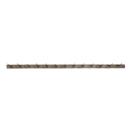 81 - A late 19th/early 20th century French butcher's hook rack. Height 5cm, width 152cm, depth 1cm. Prove... 