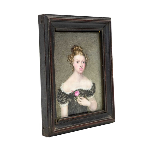819 - A portrait miniature on porcelain of a young woman. Mid 19th century, wearing a lace trimmed black d... 