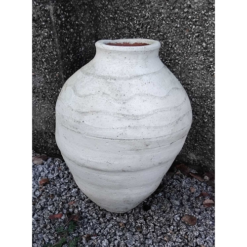862 - A white painted terracotta olive jar. Height 65cm, diameter 42cm.