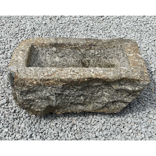 866 - A weathered granite trough. Height 30cm, width 78cm, depth 46cm.