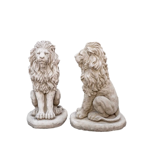 874 - A pair of cast stone sculptures of seated lions. Raised on shaped bases. Height 40cm. One of the lio... 