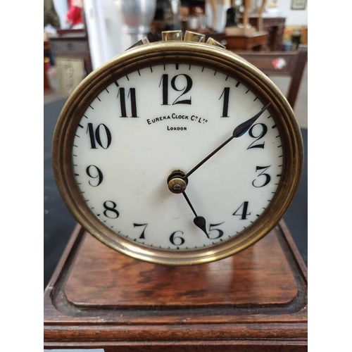 892 - A Eureka electric mantel clock. The 10cm cream enamel dial with Arabic numerals, the battery compart... 