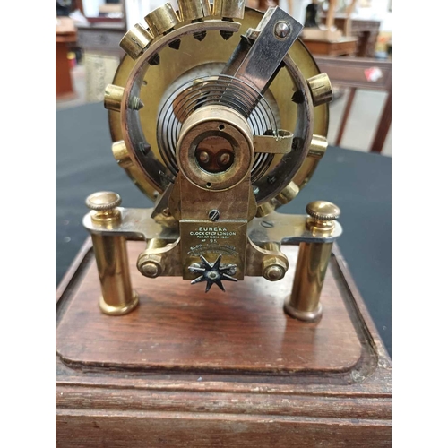 892 - A Eureka electric mantel clock. The 10cm cream enamel dial with Arabic numerals, the battery compart... 