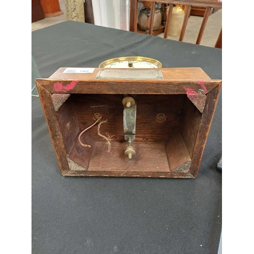 892 - A Eureka electric mantel clock. The 10cm cream enamel dial with Arabic numerals, the battery compart... 