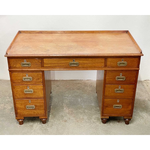 908 - A Victorian campaign type teak pedestal desk. With a raised three-quarter gallery, fitted with nine ... 