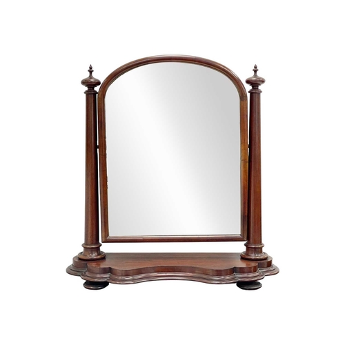 920 - A Victorian mahogany dressing table mirror. The arched plate betwixt a pair of turned columns, and w... 