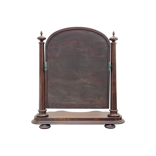 920 - A Victorian mahogany dressing table mirror. The arched plate betwixt a pair of turned columns, and w... 