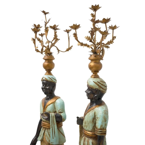 925 - Two Blackamoor type figural floor-standing candelabra. Mid 20th century, carved and painted softwood... 