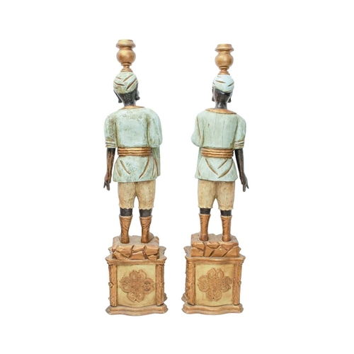 925 - Two Blackamoor type figural floor-standing candelabra. Mid 20th century, carved and painted softwood... 