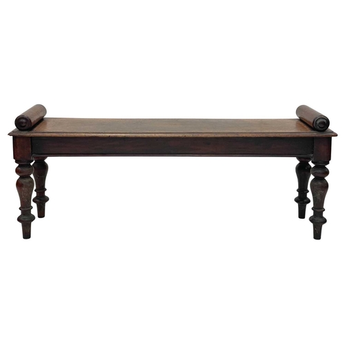 926 - A Victorian mahogany hall bench. The plank top with a moulded edge and cylinder turned ends, raised ... 