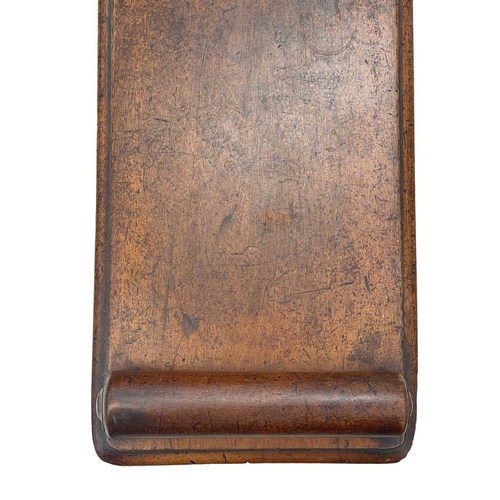 926 - A Victorian mahogany hall bench. The plank top with a moulded edge and cylinder turned ends, raised ... 