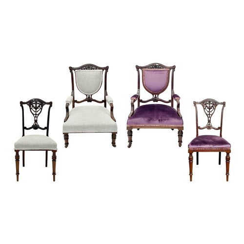 933 - An Edwardian mahogany part salon suite. Comprising two armchairs and two single chairs, with pierced... 