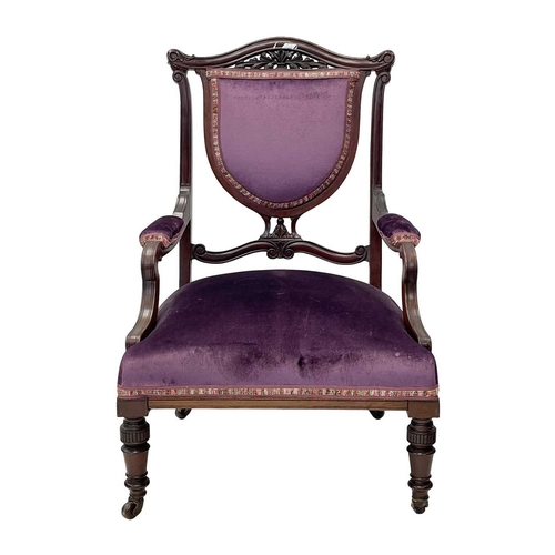 933 - An Edwardian mahogany part salon suite. Comprising two armchairs and two single chairs, with pierced... 