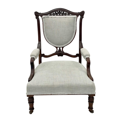 933 - An Edwardian mahogany part salon suite. Comprising two armchairs and two single chairs, with pierced... 