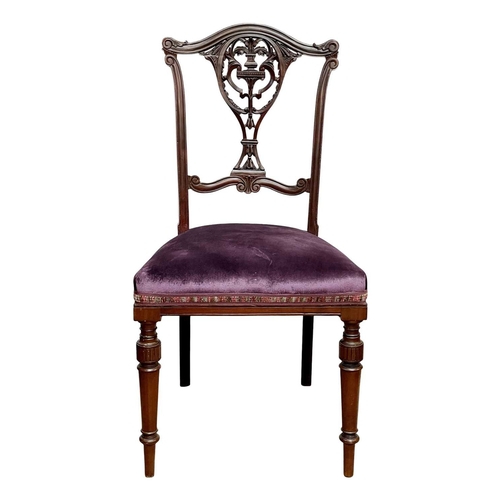 933 - An Edwardian mahogany part salon suite. Comprising two armchairs and two single chairs, with pierced... 