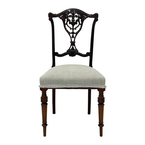 933 - An Edwardian mahogany part salon suite. Comprising two armchairs and two single chairs, with pierced... 