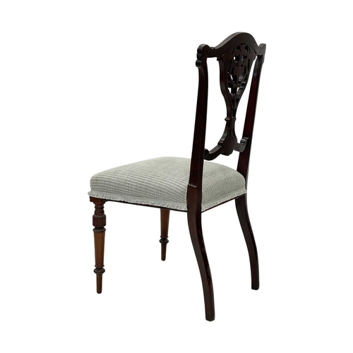 933 - An Edwardian mahogany part salon suite. Comprising two armchairs and two single chairs, with pierced... 