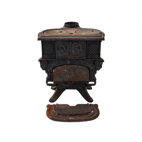 945 - A Falkirk cast iron stove. Of slight proportions, No. 6, height 49cm, width 42cm, depth 31cm.