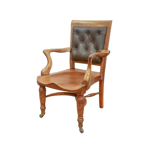 947 - A Victorian walnut desk chair. With a buttoned leather back, carved saddle seat and turned front leg... 