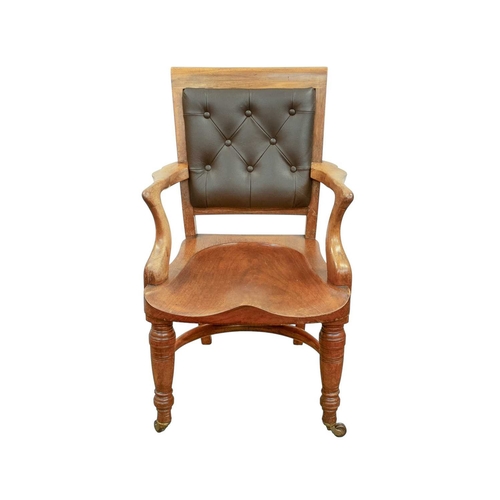 947 - A Victorian walnut desk chair. With a buttoned leather back, carved saddle seat and turned front leg... 