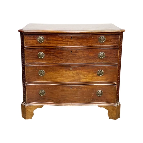 948 - A George III mahogany serpentine front chest. Fitted four graduated long drawers below a crossbanded... 