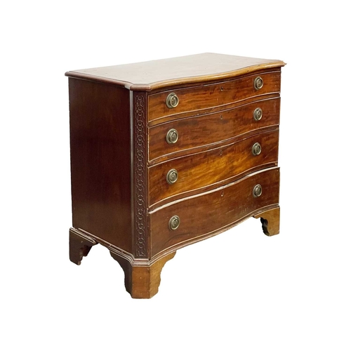 948 - A George III mahogany serpentine front chest. Fitted four graduated long drawers below a crossbanded... 
