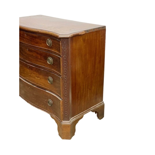 948 - A George III mahogany serpentine front chest. Fitted four graduated long drawers below a crossbanded... 
