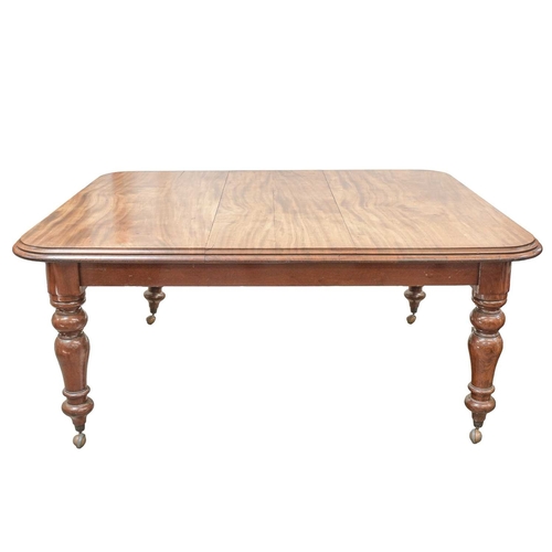 953 - A Victorian mahogany extending dining table. The top with one additional leaf, with rounded corners ... 