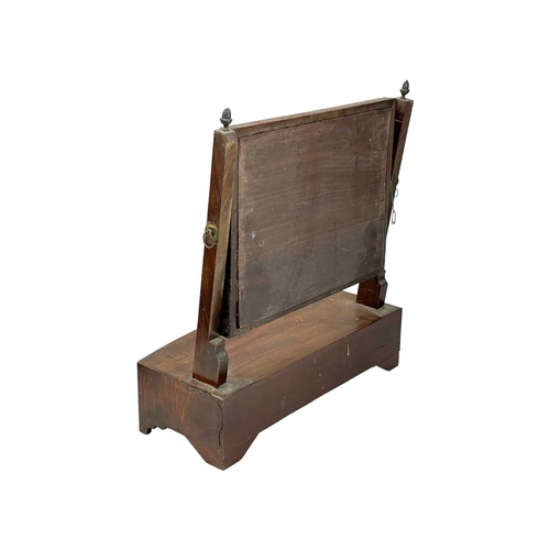 955 - A George III mahogany swing toilet mirror. Of small proportions, the base fitted a single drawer, he... 