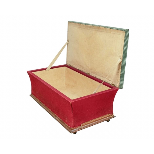 956 - A Victorian upholstered ottoman. The hinged woolwork top with a floral pattern, waisted sides, on a ... 