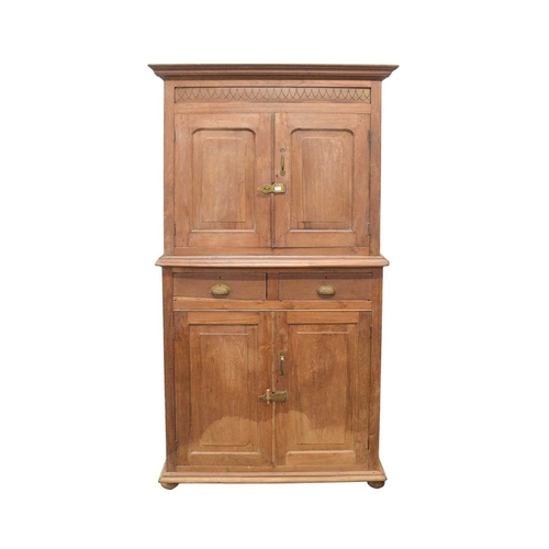 958 - An Indian teak side cabinet. Circa 1900, formed of two parts, the upper part with two doors, the low... 