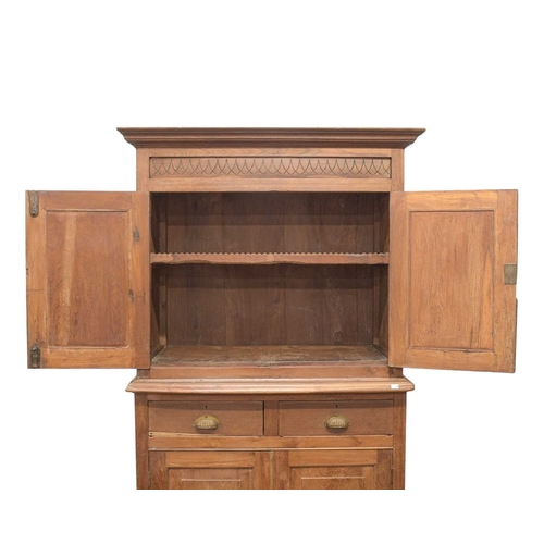 958 - An Indian teak side cabinet. Circa 1900, formed of two parts, the upper part with two doors, the low... 