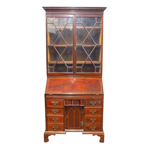 959 - A George III mahogany and inlaid bureau bookcase. With a glazed upper part above a fall front with a... 