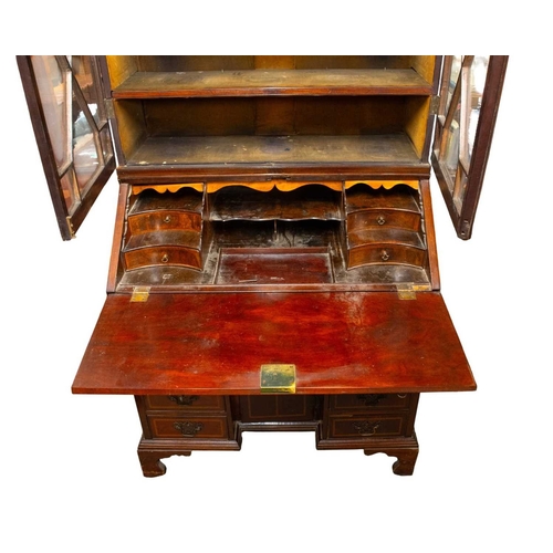 959 - A George III mahogany and inlaid bureau bookcase. With a glazed upper part above a fall front with a... 