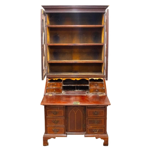 959 - A George III mahogany and inlaid bureau bookcase. With a glazed upper part above a fall front with a... 