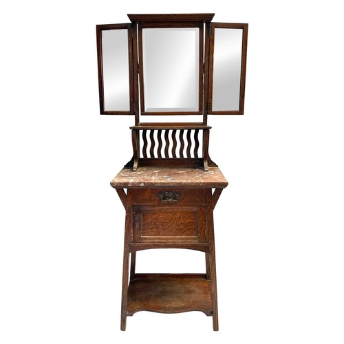 960 - An Arts and Crafts oak dressing stand. The upper part with a folding triptych mirror above a shelf w... 