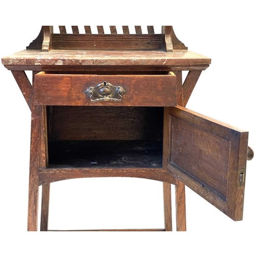 960 - An Arts and Crafts oak dressing stand. The upper part with a folding triptych mirror above a shelf w... 