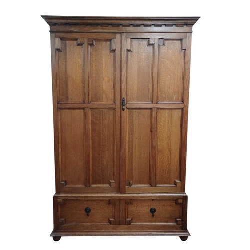 968 - An oak press cupboard. Early 20th century, the panel doors enclosing five sliding shelves, with a dr... 