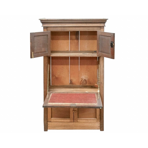 977 - An oak Arts and Crafts cabinet. Fitted with two doors with pressed copper panels and strap hinges, a... 