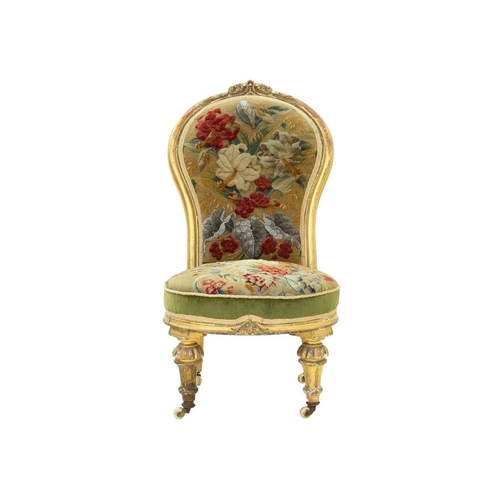 978 - A Victorian giltwood nursing chair. The balloon shape back with carved crest and with woolwork and b... 