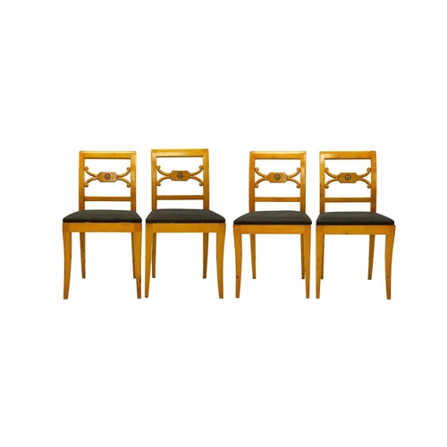 979 - A set of four Biedermeier style dining chairs. The centre rails with burr panels centering a gilt pa... 