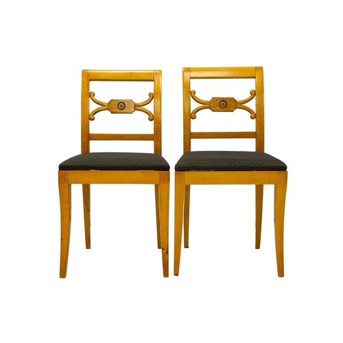979 - A set of four Biedermeier style dining chairs. The centre rails with burr panels centering a gilt pa... 