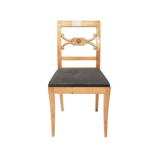 979 - A set of four Biedermeier style dining chairs. The centre rails with burr panels centering a gilt pa... 