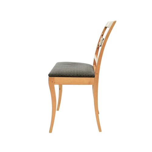 979 - A set of four Biedermeier style dining chairs. The centre rails with burr panels centering a gilt pa... 