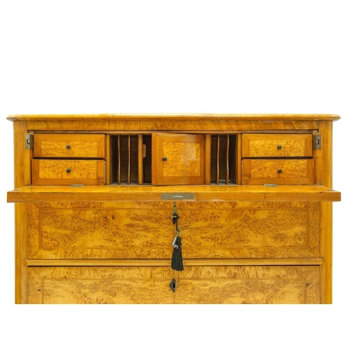 985 - A Biedermeier satin birch secretaire chest. 19th century, the hinged fall fitted a central cupboard,... 