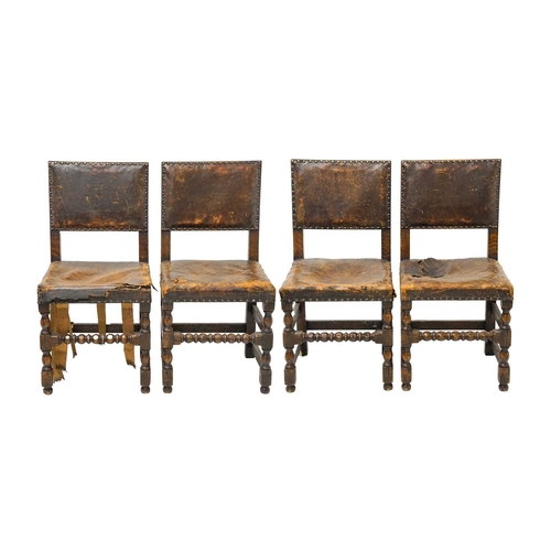 986 - A set of four Cromwellian style oak and leather upholstered dining chairs. .